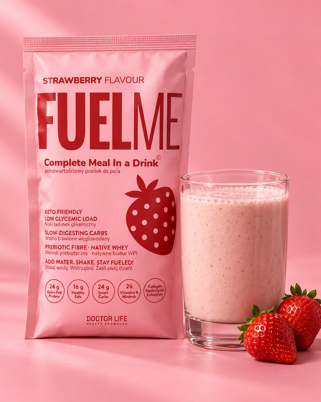 FUELME Strawberry sachet beside a creamy strawberry shake on a pink studio background